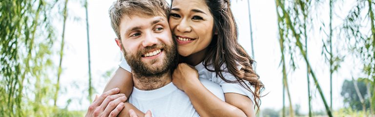 happy smiling couple hugging eachother for a photo