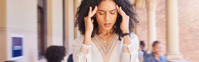 Woman Holding Her Hands to Her Head with a Headache