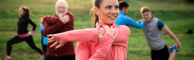 Large group of fit people stretching for a run